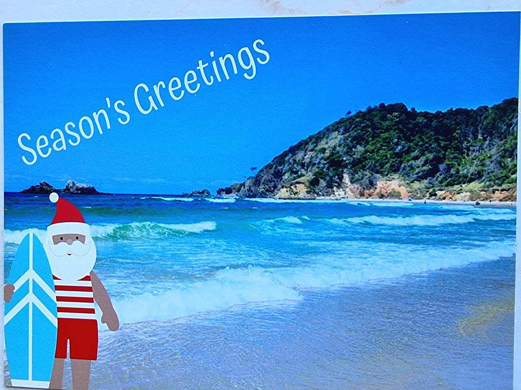 Seasons Greetings Surfboard Santa at Beach